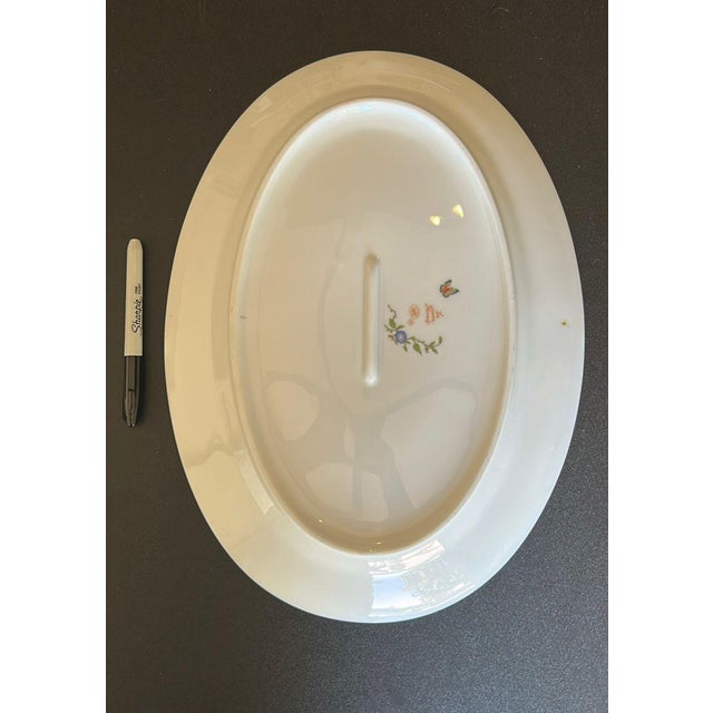 Beautiful Hermès “La Siesta” oval porcelain serving platter featuring vibrant floral, fruit, and butterfly artwork with...