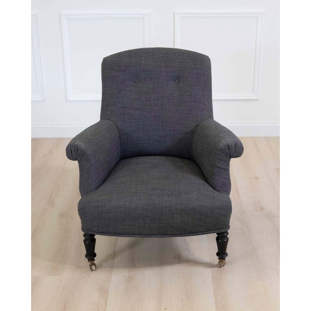 Elegant French armchair dating to the early 20th century, circa 1910. This handsome chair features a generously...