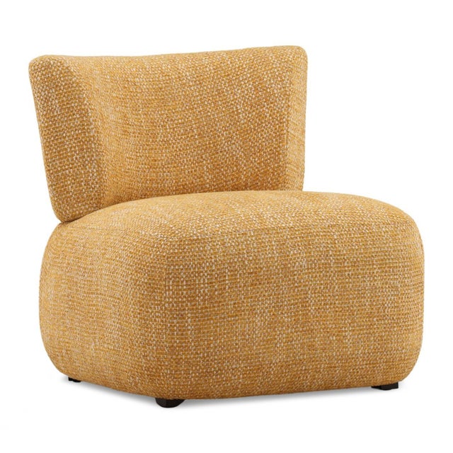 Sculptural soft lounge chair featuring a gently curved back and low, grounded profile. Upholstered in a richly textured...