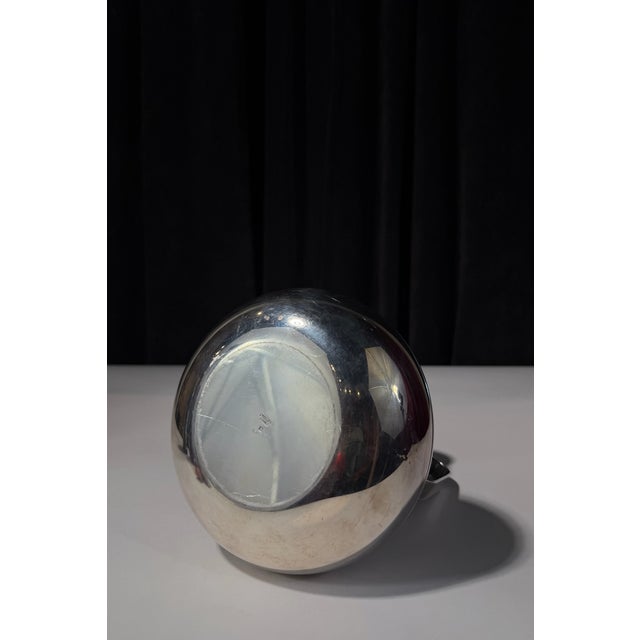A Luc Lanel design for Christofle, this pitcher belongs to the streamlined world of French Art Deco tableware—where...