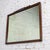 Lovely vintage Traditional or Regency style rectangular wall mirror composed of a rectangular walnut toned hardwood frame...