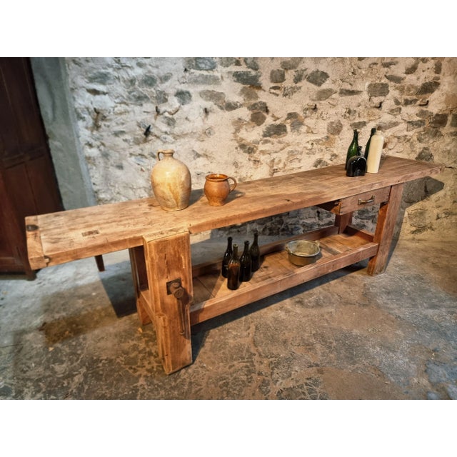 A stunning vintage French workbench crafted from solid beech wood, dating from the early 20th century (circa 1900–1930)....