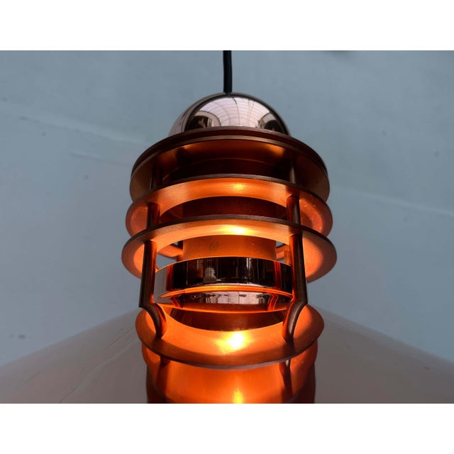 An elegant pendant light by the Danish manufacturer Louis Poulsen, designed by Alfred Homann and Ole V. Kjær in the 1980s....