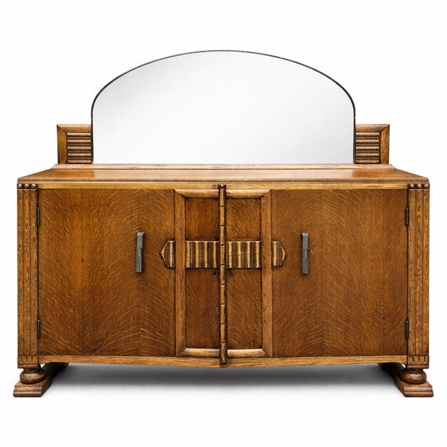 A striking Arts & Crafts era oak dresser sideboard, featuring beautifully patterned oak grain and bold geometric...