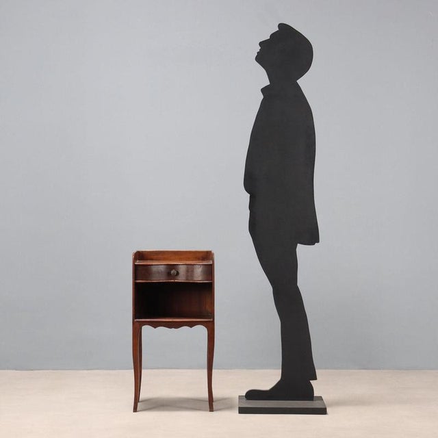 Mahogany bedside table. Upper drawer with curved front, open compartment underneath, curved legs and apron. France, 20th...