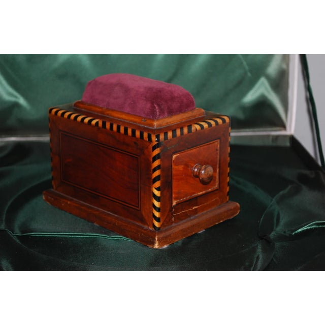 Beautiful, hand crafted pin cushion box. Great detail striped band lining the box. Inlaid wood design on sides. Red velvet...