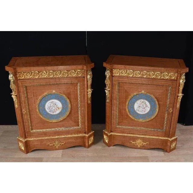 A pair of french napoleon iii, satinwood side cabinets, circa 1910. Adorned with fine quality ormolu mounts. Each centre...