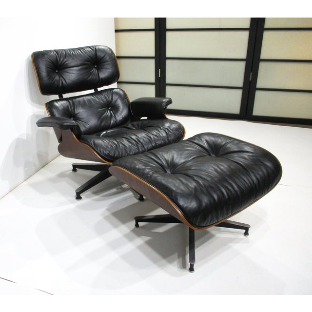 An iconic Brazilian rosewood framed 670 lounge chair with the matching 671 ottoman all in luxurious smooth soft black...