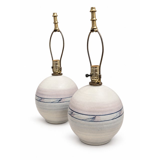 A distinctive pair of late-20th-century studio pottery table lamps featuring generously scaled, rounded ceramic bodies...