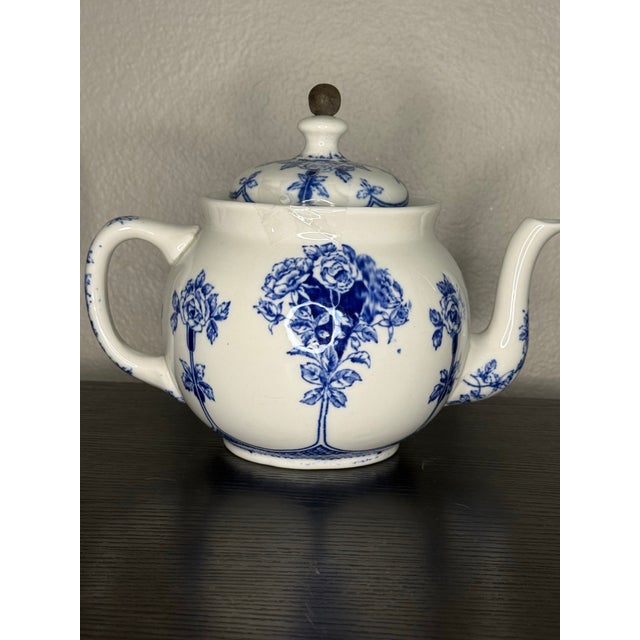 This is a Buffalo Pottery Argyle pattern teapot. The teapot features a blue and white floral design, specifically an...