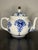 This is a Buffalo Pottery Argyle pattern teapot. The teapot features a blue and white floral design, specifically an...