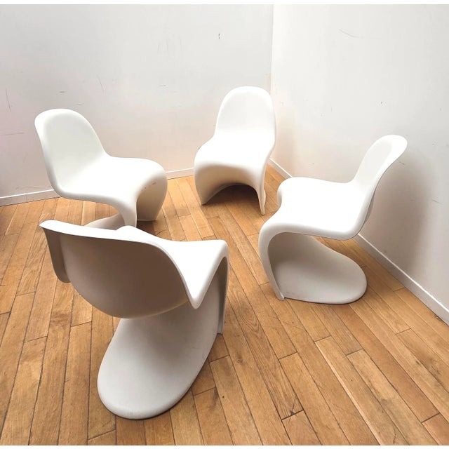 Set of four Verner Panton designer chairs, Vitra. Entirely made of white plastic. Original design. Minor signs of wear....