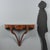 Teardrop-shaped walnut console table. Molded top with a central rosette inlaid with maple, which also appears on the...