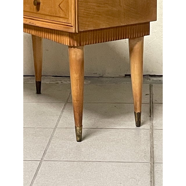 Elegant pair of mid-century modern Italian bedside tables, dating back to the 1940s and 1950s. Maple wood frame with...