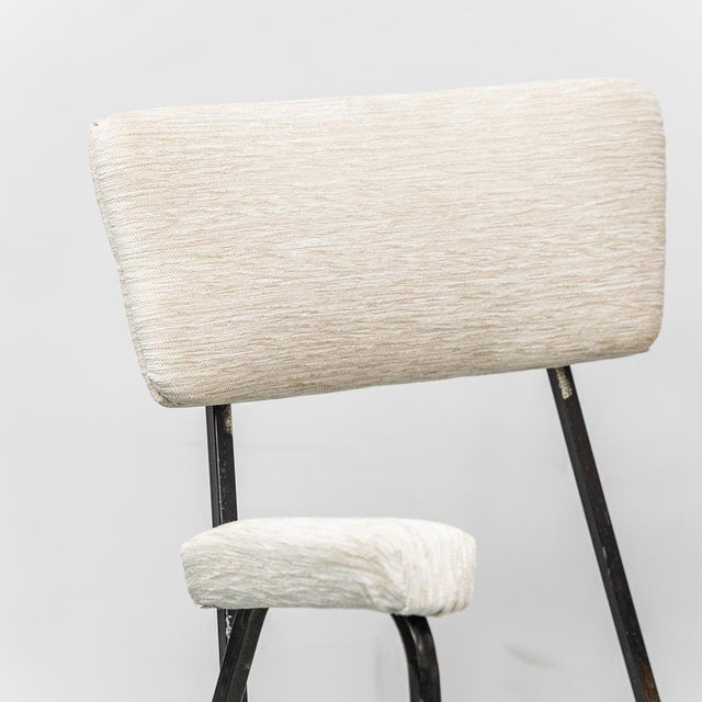 Set consisting of a sofa and two armchairs made in the 1970s. Fabric upholstery, metal frame, and brass feet. The item is...