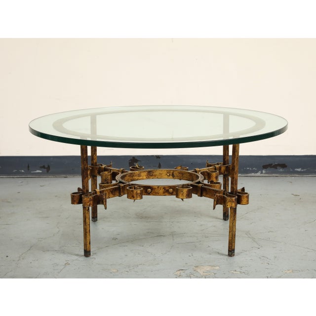 1950s French hand-forged iron parcel-gilt coffee/cocktail table with original 3/4" glass top, designed in the manner of...