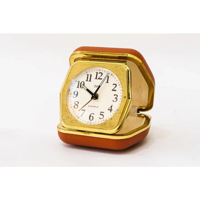 Travel alarm clock "JMS", germany around 1950s Original condition Brass with red faux leather cover Still working...