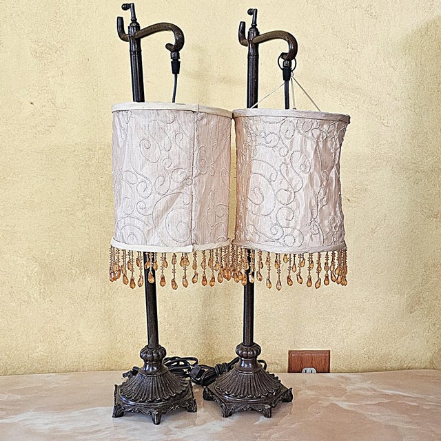 Elegant pair of vintage bridge-arm table lamps, circa early 2000s, combining Traditional and Hollywood Regency-inspired...