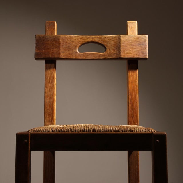 ​This pair of striking solid oak chairs impresses with its sculptural presence and high-quality craftsmanship. The design...