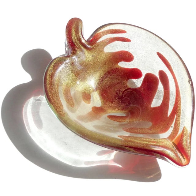 Beautiful vintage Murano hand blown deep ruby red and gold flecks Italian art glass leaf shape bowl. The piece has a...