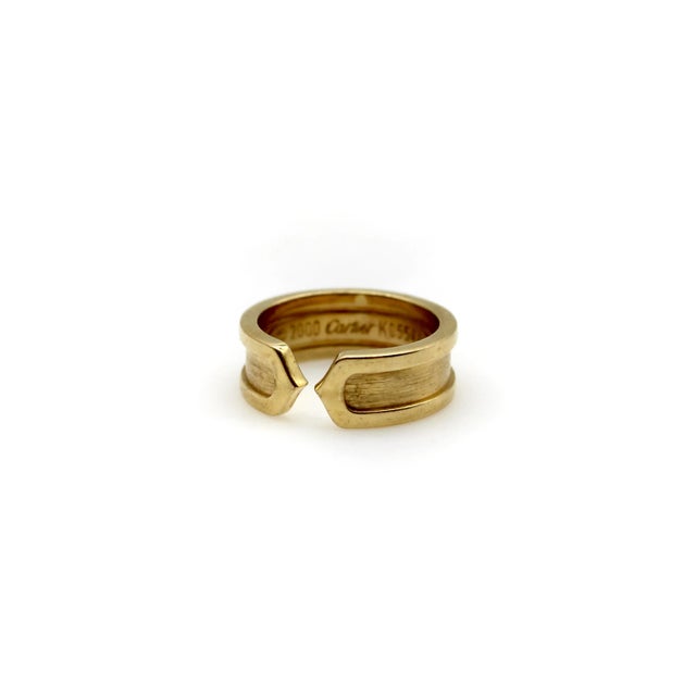 This is part of Chairish's Fine Jewelry Collection. This 18k gold ring is a play on the classic double-c Cartier design....