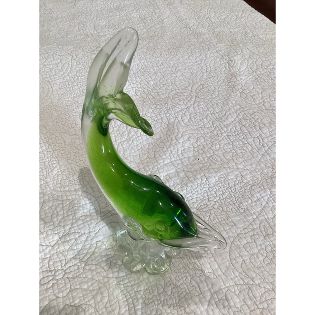 A green dolphin imported by JICO in the1950s. Found the exact fish on Etsy with a red Murano label It was clear without...