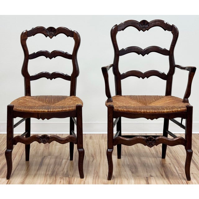 Stunning set of six (6) antique French Country style carved walnut dining chairs. Set features two (2) armchairs and four...