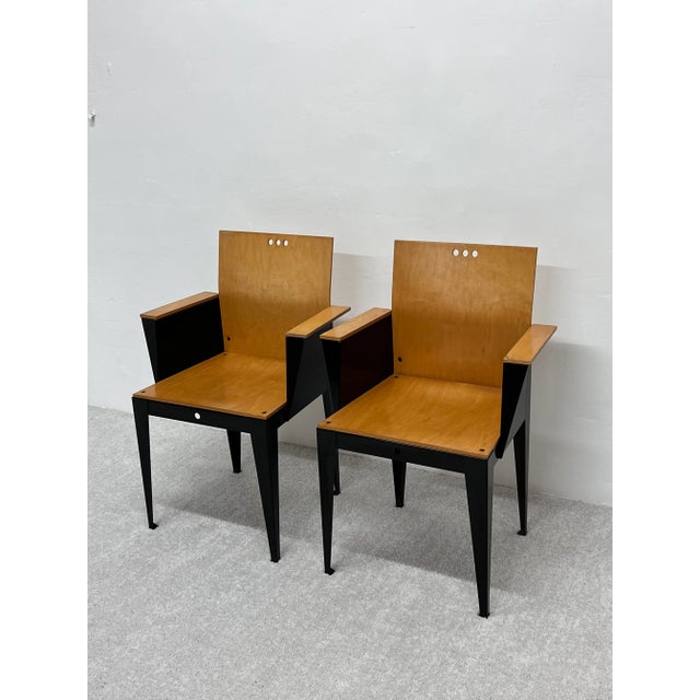 Rare pair of Eli Armchairs with maple wood seat, back and arms attached to a black powder coated steel base. Designed by...