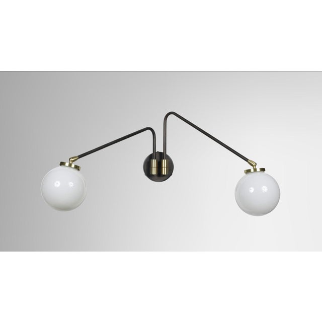 This elegant CTO Lighting Array Twin Opal wall lamp features a striking bronze finish paired with spherical white opal...