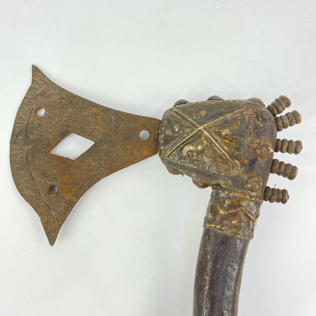 A finely crafted ceremonial blade from the Bamun people, combining elements of both knife and axe. The form is enhanced...