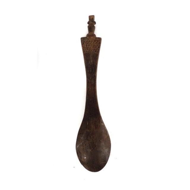 The Nyamwezi Mwana Hiti Spoon hails from Tanzania, showcasing remarkable craftsmanship and cultural significance. Carved...