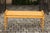 An English vintage painted wooden bench from the mid-20th century, with cylindrical armrests and faux bamboo legs. Born in...
