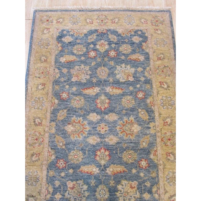 This blue wool runner rug features a classic Rabat style design with a hand knotted pile weave. The primary blue color...