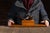 Figural wooden pipe rack designed in the form of an oversized long-stemmed tobacco pipe, with the stem drilled to accept...