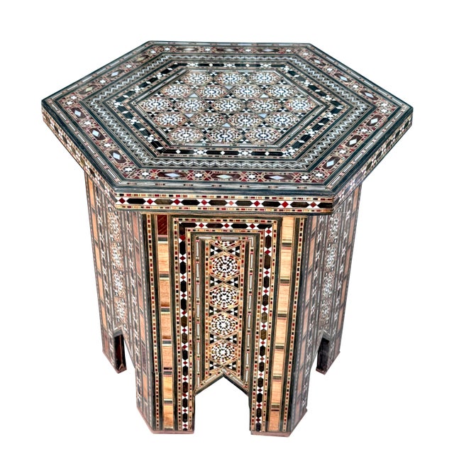 An elegant vintage hexagonal side table showcasing exceptional marquetry wood inlay enhanced with luminous mother-of-pearl...