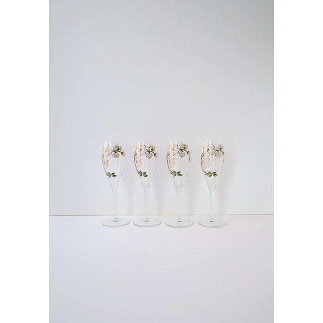 A beautiful set of four (4) vintage Perrier-Jouet French champagne flute glasses with iconic floral motif in the Art...