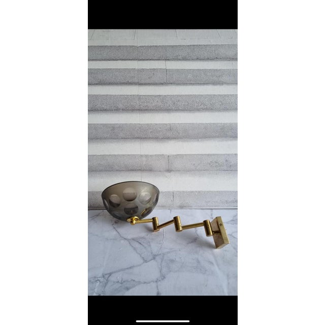 Vintage Smoked Glass Arm Sconce Designer: Oscar Torlasco attributed Material: Smoke hand-blown glass shade, rose gold...