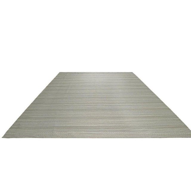 This hand knotted pile rug features a primary gray color palette and is crafted from durable wool. Made in India, this...