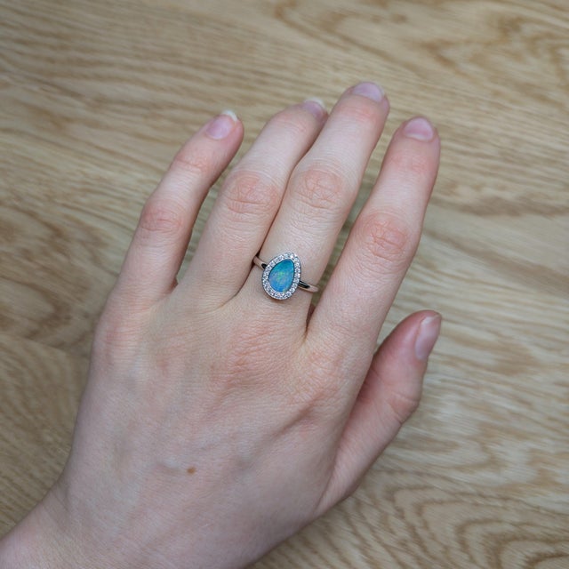 This ring is a breathtaking masterpiece that showcases the mesmerizing beauty of a 1.08ct Boulder Opal. Set in stunning...