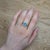 This ring is a breathtaking masterpiece that showcases the mesmerizing beauty of a 1.08ct Boulder Opal. Set in stunning...