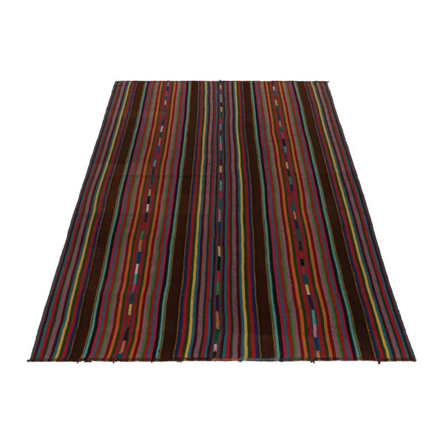 Handwoven in Turkey originating between 1950-1960, this 7x10 vintage Chaput style Kilim rug enjoys an appealing variation...