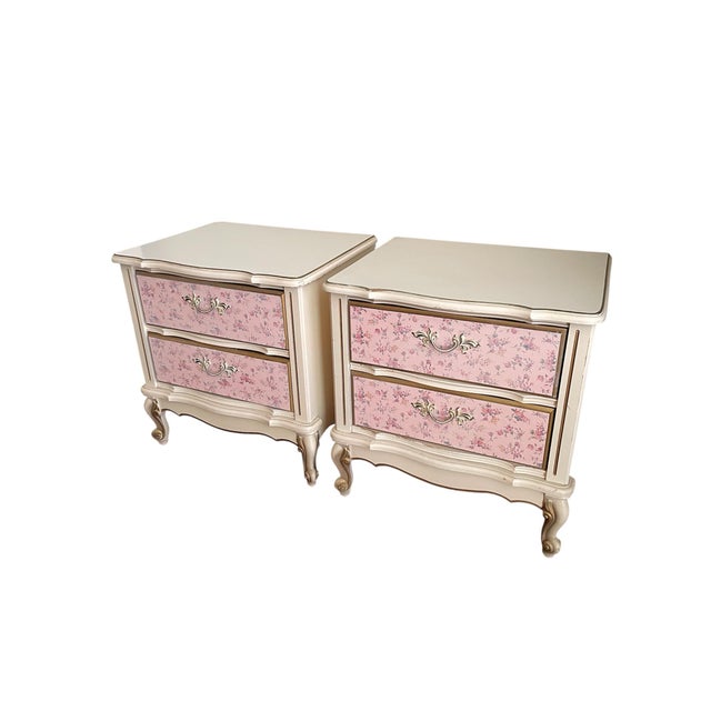 A charming pair of vintage French Provincial nightstands dating to the 1960s, featuring softly scalloped silhouettes,...