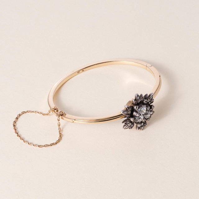 Victorian era Antique Diamond Floral Hinged Bangle 14K Yellow Gold & Sterling Silver | Circa 1890s A beautifully preserved...