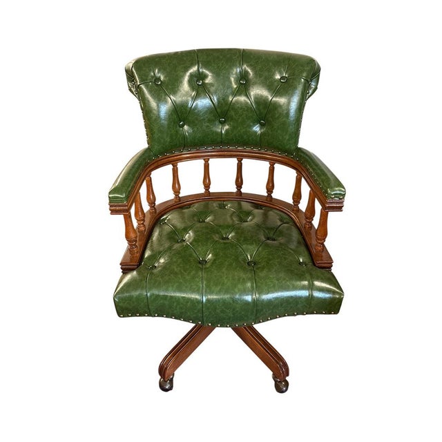 English chesterfield style captain’s chair with green tufted leather and brass studs, turned wooden spindles, solid beech...