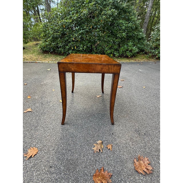 Large rectangular side table made of burled wood. Dark honey colored.