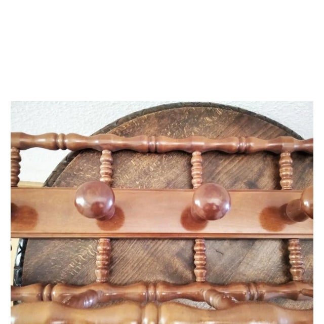 It is in perfect condition, like new. This natural color wooden coat rack has 4