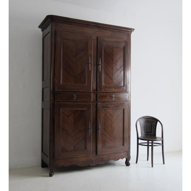 Large French provincial cabinet from the late 18th or early 19th century. Solid cherry and oak. An authentic piece of...