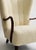 A Danish wingback lounge chair, circa 1960s, attributed to Alfred Christensen. Recently reupholstered in cream lambswool,...