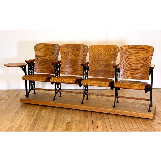 Late 19th century unique folding four seat auditorium unit with tiger oak seats and backs and a black cast iron frame. The...