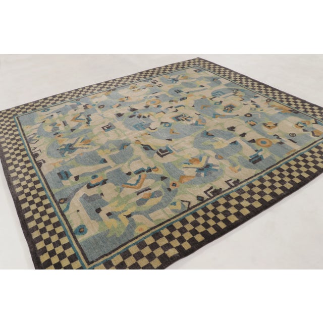 This 9x10 contemporary Art Deco rug, hand-knotted in wool, presents an expressive geometric design framed by a bold...